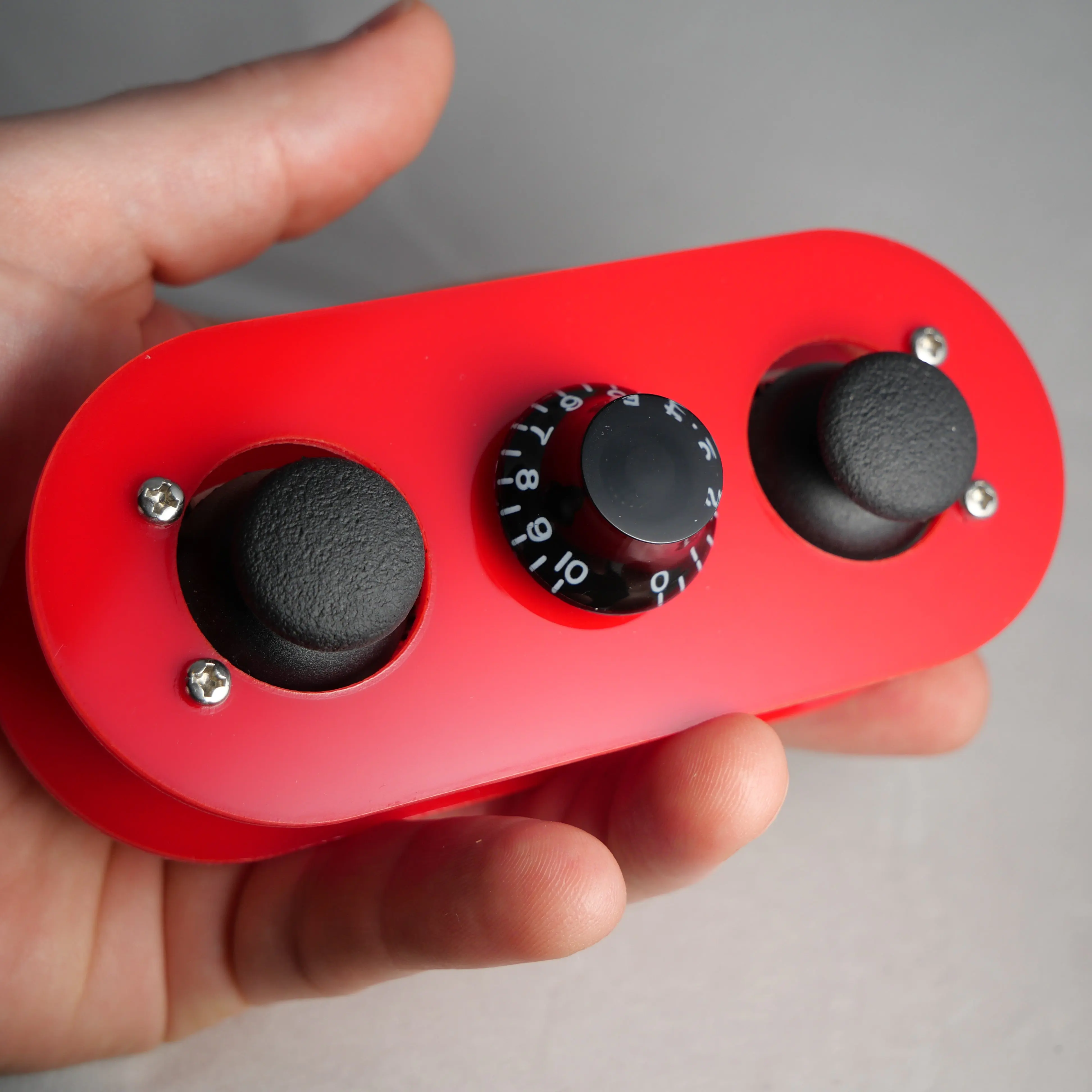 The Pill MIDI controller held in one hand